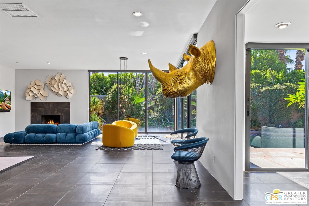 1075 East Suntan Lane Palm Springs, CA 92264 - Photo 6 of 39 a living room with furniture and a fireplace