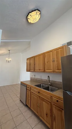 a kitchen with stainless steel appliances granite countertop a sink and a refrigerator