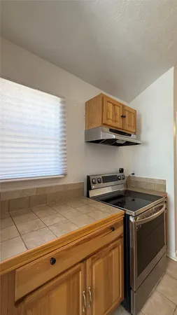 a kitchen with stainless steel appliances granite countertop a sink a stove and a microwave