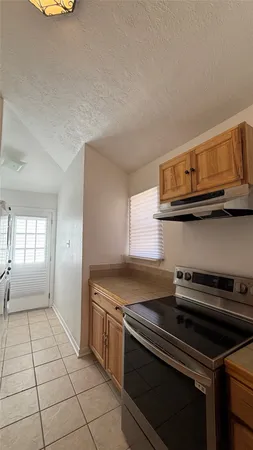 a kitchen with stainless steel appliances a sink dishwasher stove and cabinets