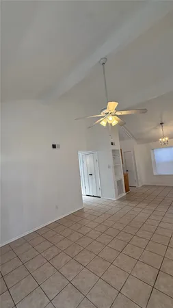view of a hallway with a glass door and a bathroom