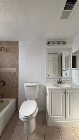 a bathroom with a toilet and a bath tub
