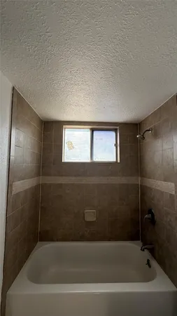 a white toilet sitting next to a bath tub and a shower