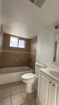 a spacious bathroom with a granite countertop sink a mirror and a vanity