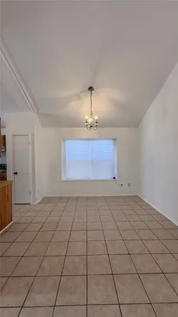 an empty room with a ceiling fan and window