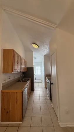 a kitchen with stainless steel appliances granite countertop a sink and a refrigerator