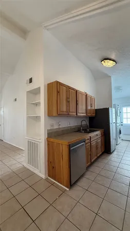 a kitchen with stainless steel appliances a sink and cabinets
