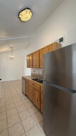 a kitchen with stainless steel appliances granite countertop a refrigerator sink and stove