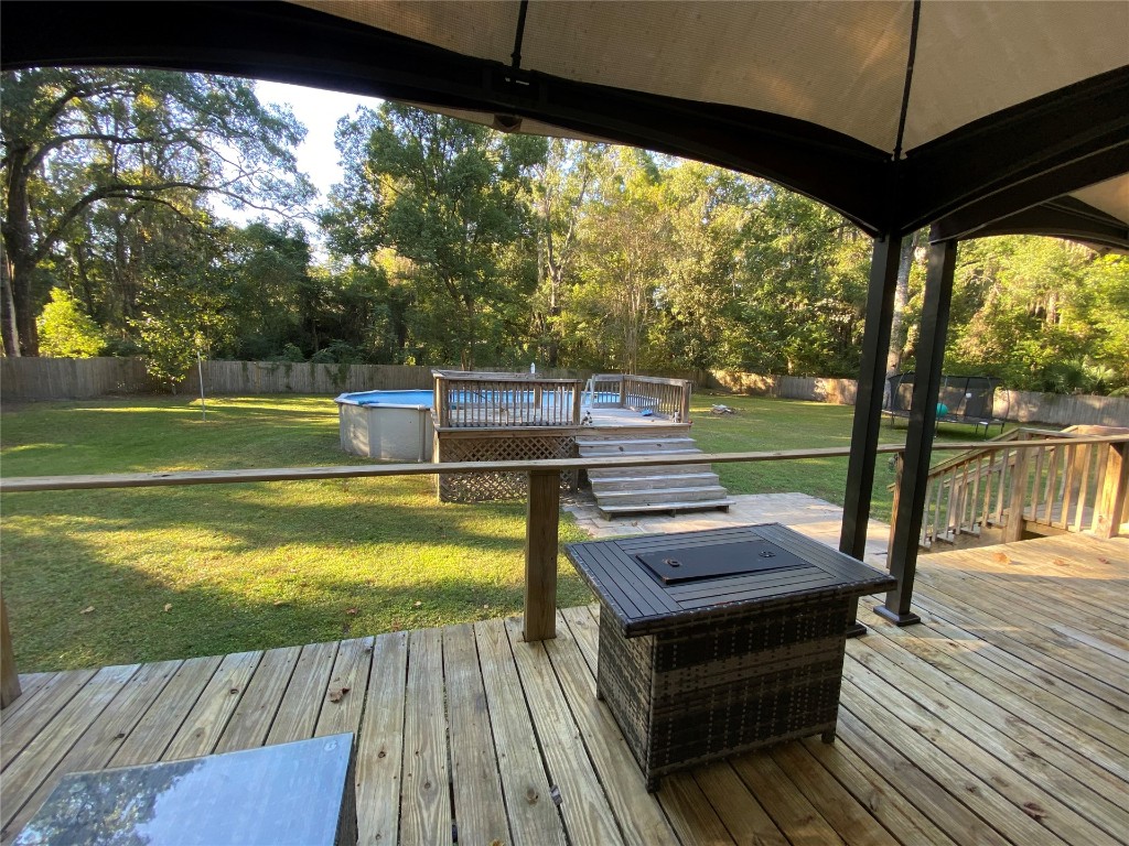 44079 Lee Drive Callahan, FL 32011 - Photo 14 of 32 a view of a patio with dining table and chairs
