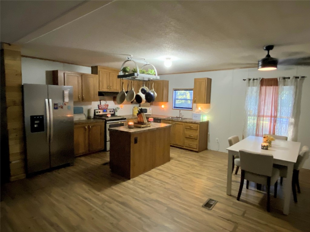44079 Lee Drive Callahan, FL 32011 - Photo 15 of 32 a kitchen with refrigerator cabinets and wooden floor