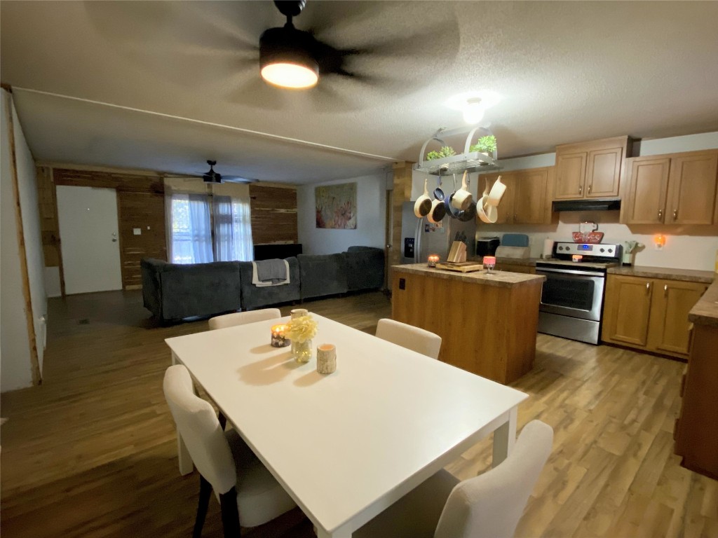 44079 Lee Drive Callahan, FL 32011 - Photo 17 of 32 a kitchen with kitchen island a stove a table and chairs in it