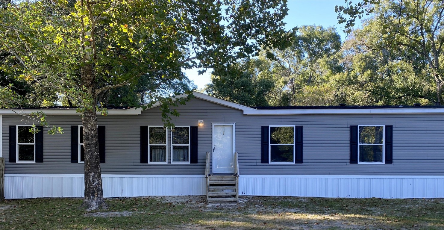 44079 Lee Drive Callahan, FL 32011 - Photo 2 of 32 front view of house with a yard