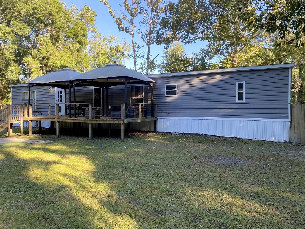 44079 Lee Drive Callahan, FL 32011 - Photo 3 of 32 a backyard of a house with barbeque oven table and chairs