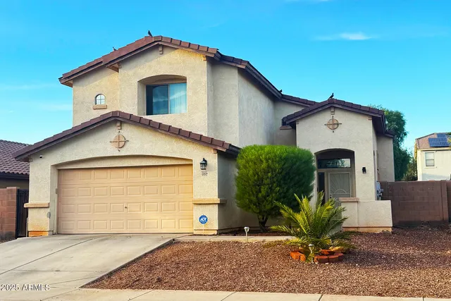 a view of a house with a yard and garage