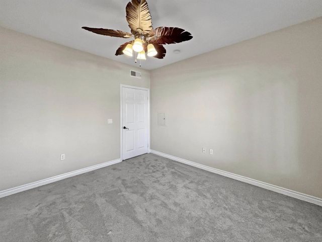 a view of a small space with a chandelier fan