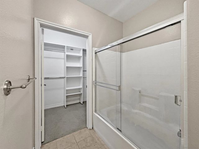 a bathroom with a glass shower door