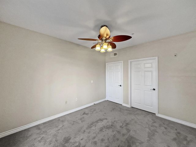 a view of a big room with windows fan