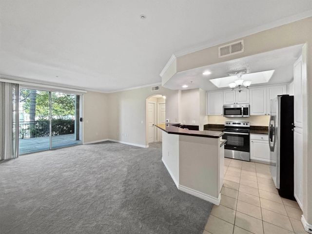 a kitchen with a sink cabinets and stainless steel appliances