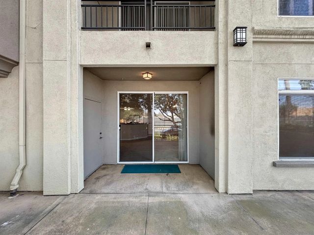 a view of a pathway with a wrought fence