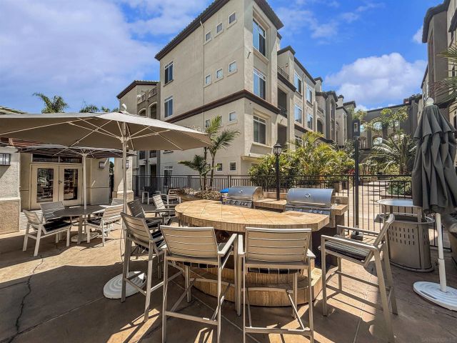 a view of a patio with a table and chairs under an umbrella