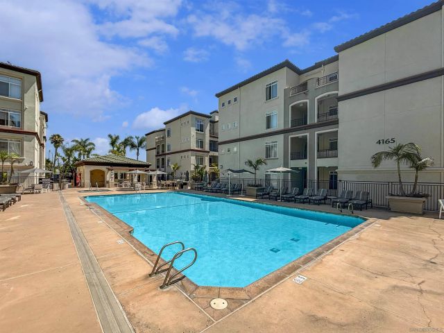a swimming pool with outdoor seating and yard