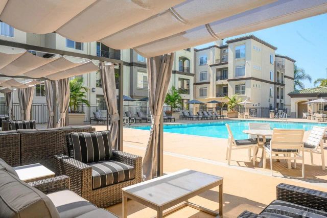 a view of a patio with couches table and chairs and potted plants