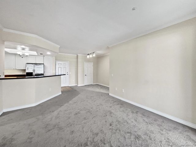 a view of a kitchen with a refrigerator and a sink