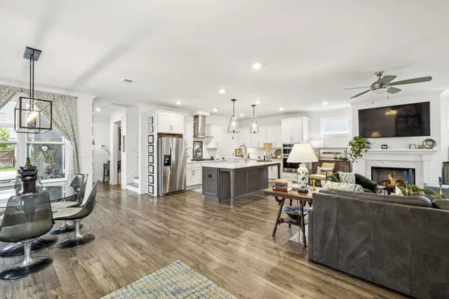 a kitchen with stainless steel appliances granite countertop a refrigerator a stove a sink and a oven