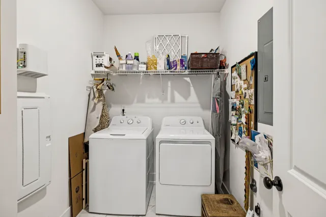 a living room with furniture a rug and a bookshelf