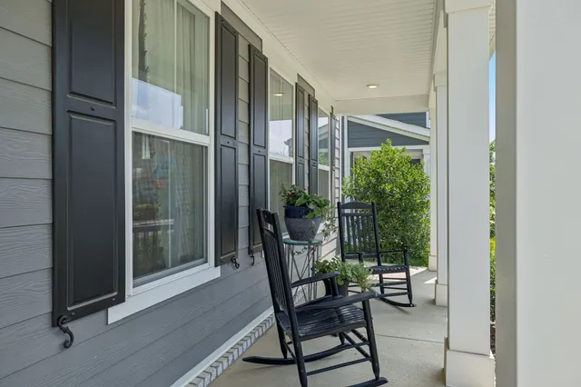 a view of a porch with chairs and backyard