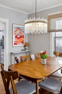a view of a dining room with furniture and chandelier