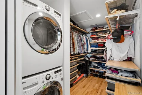 a view of walk in closet with clothes and shoes