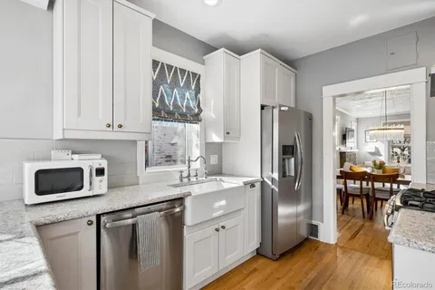 a kitchen with stainless steel appliances a refrigerator sink and microwave