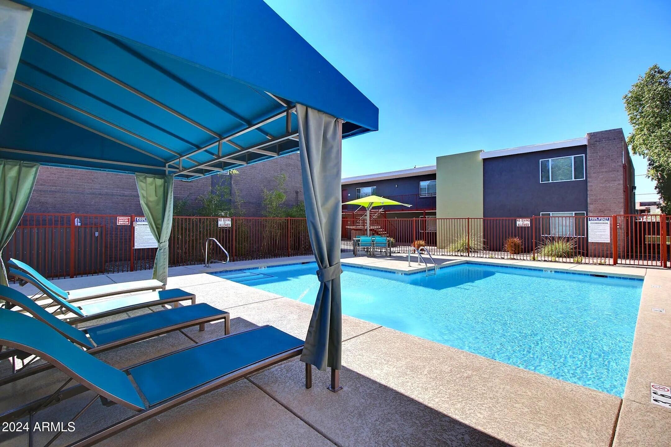 1220 North 44th Street, Unit 1 Phoenix, AZ 85008 - Photo 13 of 15 a swimming pool with outdoor seating and yard