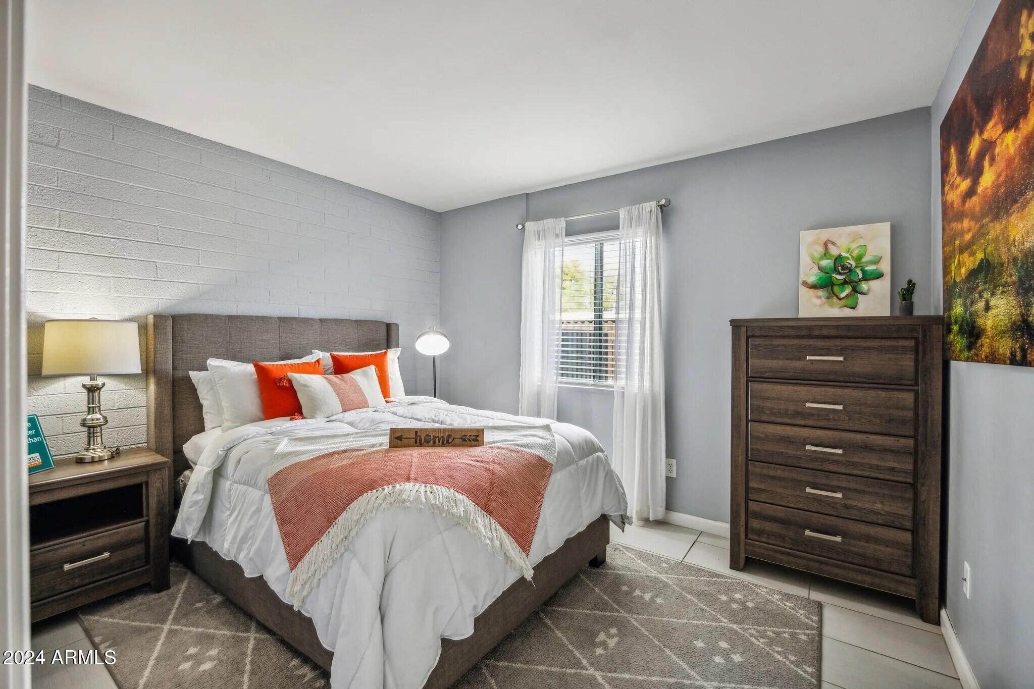 1220 North 44th Street, Unit 1 Phoenix, AZ 85008 - Photo 7 of 15 a bedroom with a bed and a window