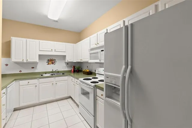a kitchen with cabinets and white appliances
