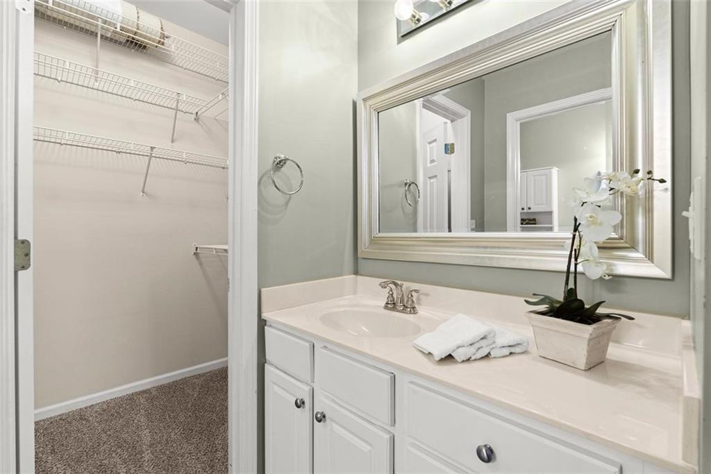 1225 Creek Forest Lane Austell, GA 30106 - Photo 16 of 32 a bathroom with a sink and a mirror