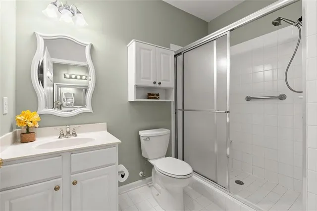 a bathroom with a sink vanity mirror and toilet