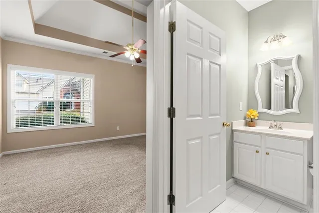 a view of a bathroom with a mirror and a sink