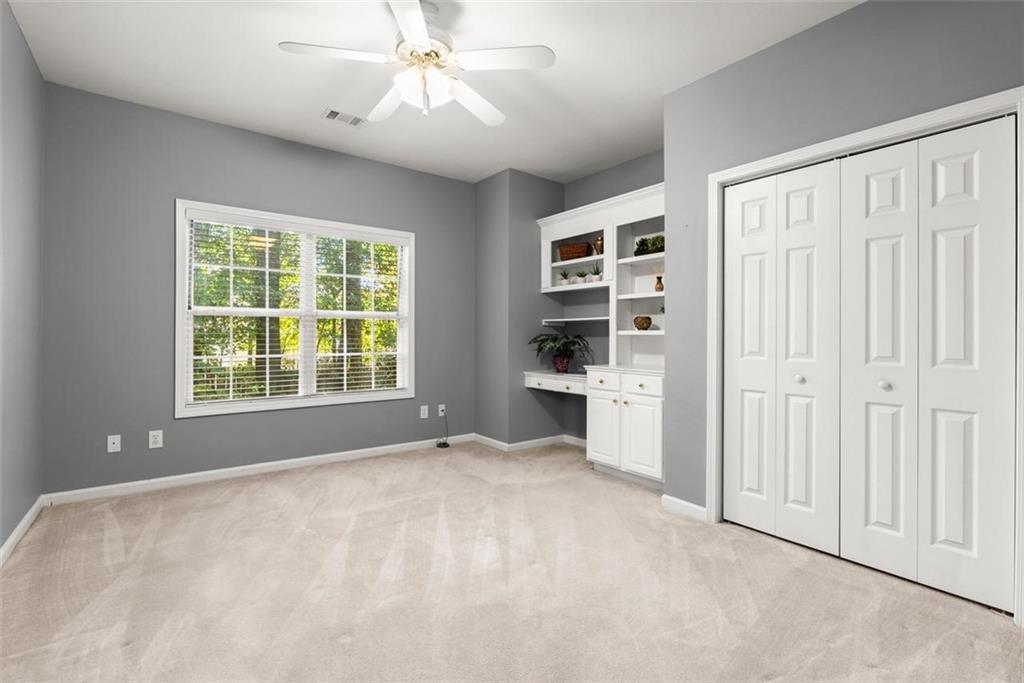 1225 Creek Forest Lane Austell, GA 30106 - Photo 21 of 32 a view of a bedroom with cabinet and a ceiling fan