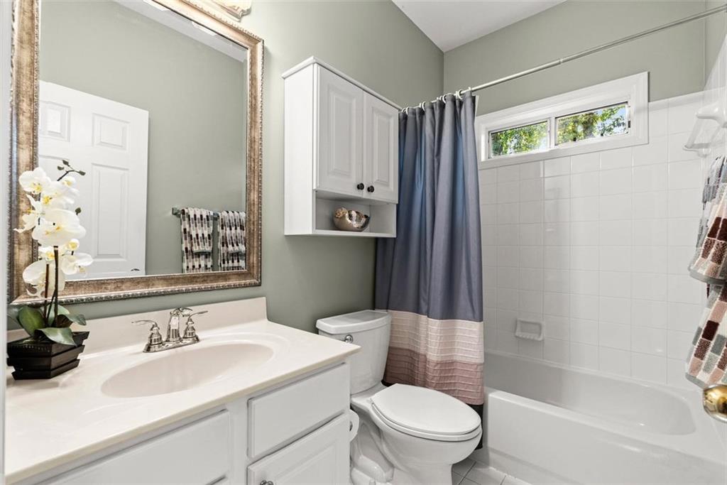 1225 Creek Forest Lane Austell, GA 30106 - Photo 23 of 32 a bathroom with a sink a toilet and shower