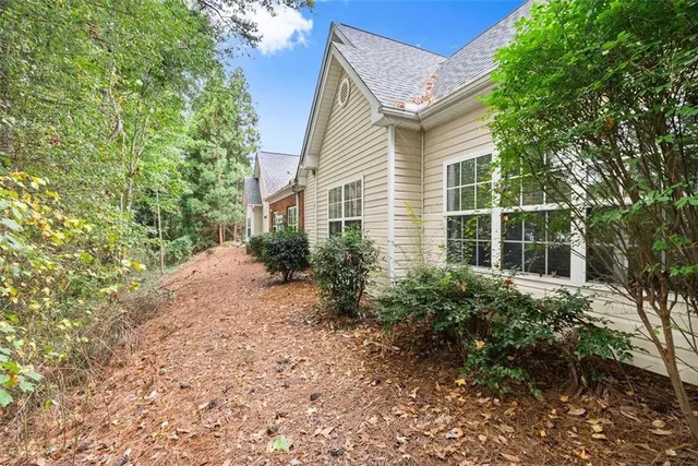 a view of a house with a yard and potted plants