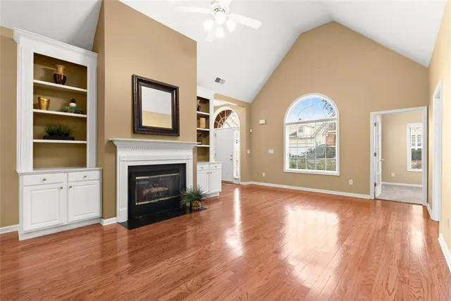 a view of an empty room with a fireplace and a window