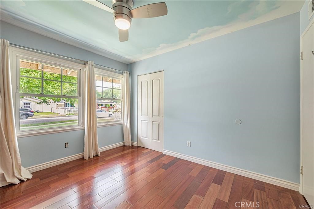 20129 Halsted Street Chatsworth, CA 91311 - Photo 18 of 31 an empty room with wooden floor and windows