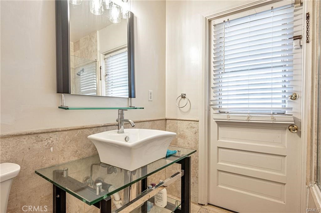 20129 Halsted Street Chatsworth, CA 91311 - Photo 20 of 31 a bathroom with a sink a toilet and a mirror