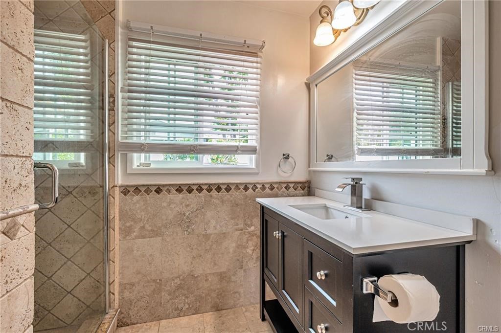 20129 Halsted Street Chatsworth, CA 91311 - Photo 23 of 31 a bathroom with a sink and a vanity