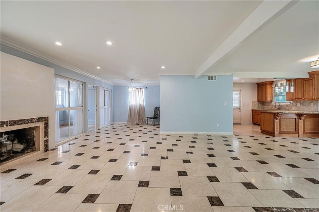 20129 Halsted Street Chatsworth, CA 91311 - Photo 6 of 31 a large kitchen with a checkered floor and a fireplace