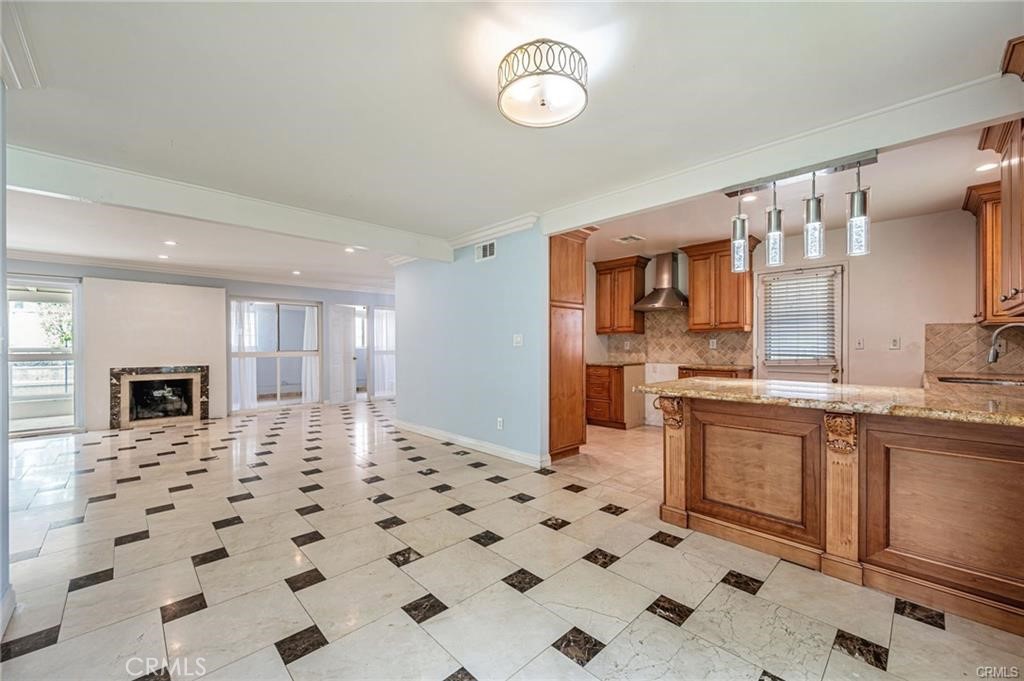 20129 Halsted Street Chatsworth, CA 91311 - Photo 9 of 31 a kitchen with stainless steel appliances a sink and a refrigerator