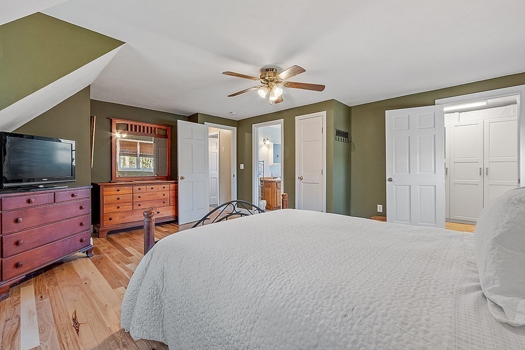 258 West Road Ashby, MA 01431 - Photo 17 of 42 a bedroom with a bed and a flat screen tv