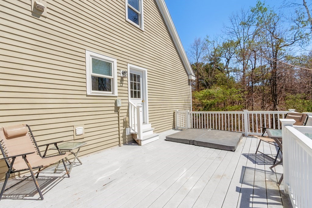 258 West Road Ashby, MA 01431 - Photo 33 of 42 a view of a deck with a table and chair and wooden floor